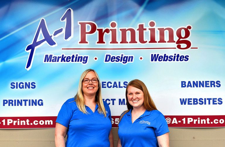 A-1 sales staff standing with custom banner